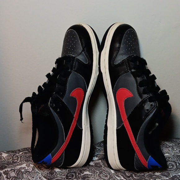 black nike shoes with red swoosh